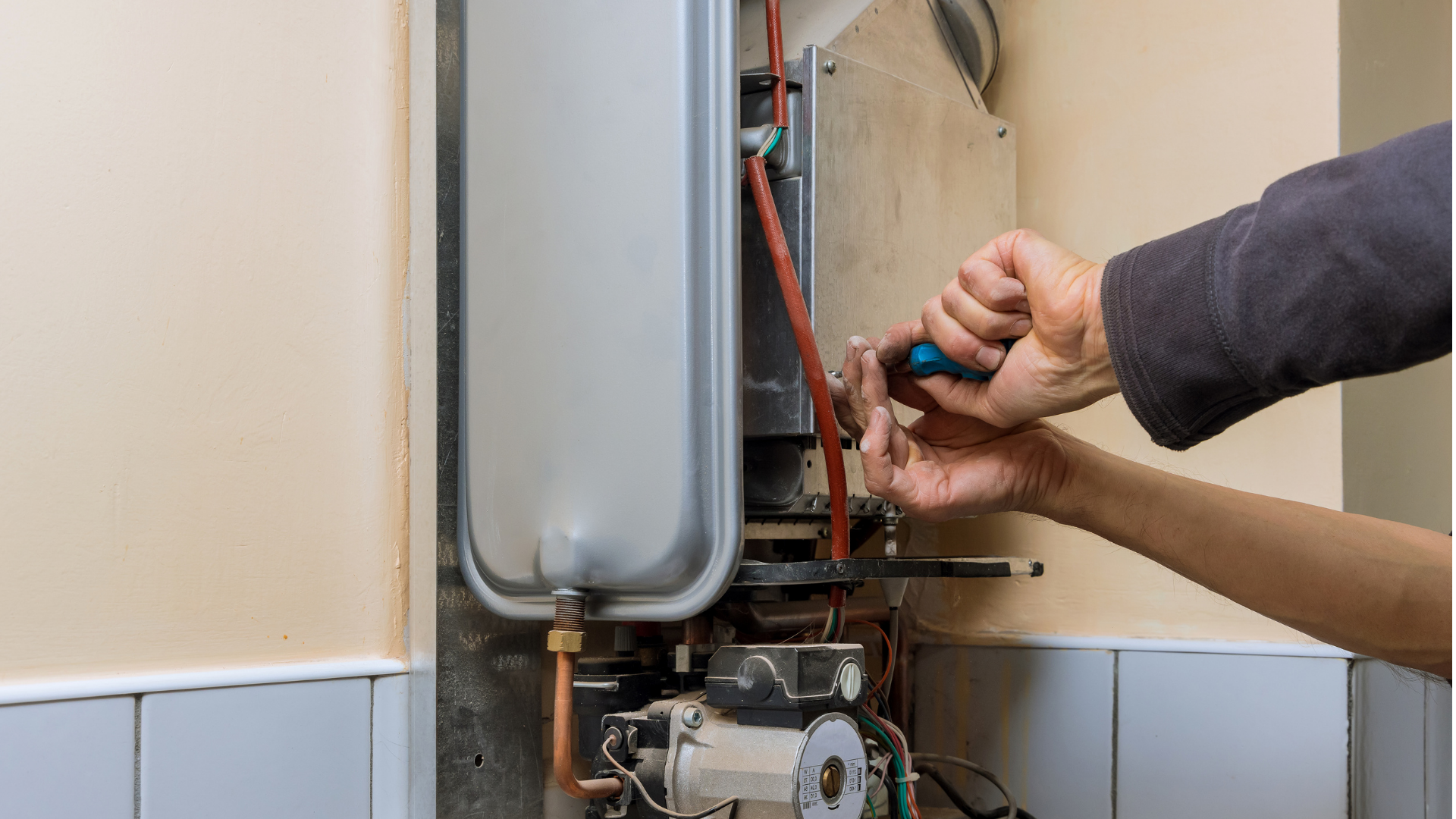 Professional plumber repairing a tankless water heater system in Aledo, TX