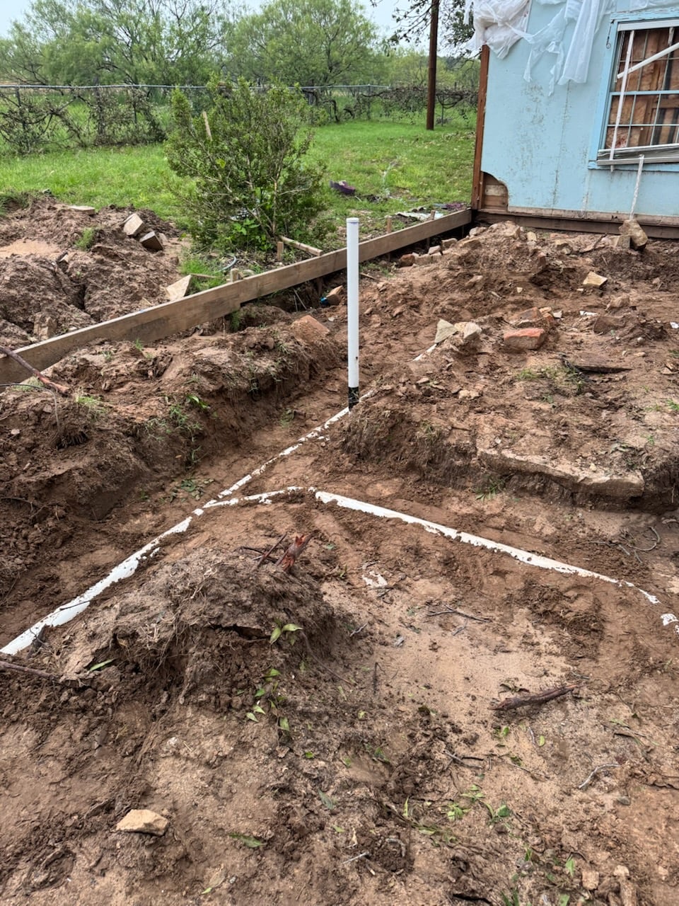 Marked sewer line trench layout before excavation at a home in Aledo, TX