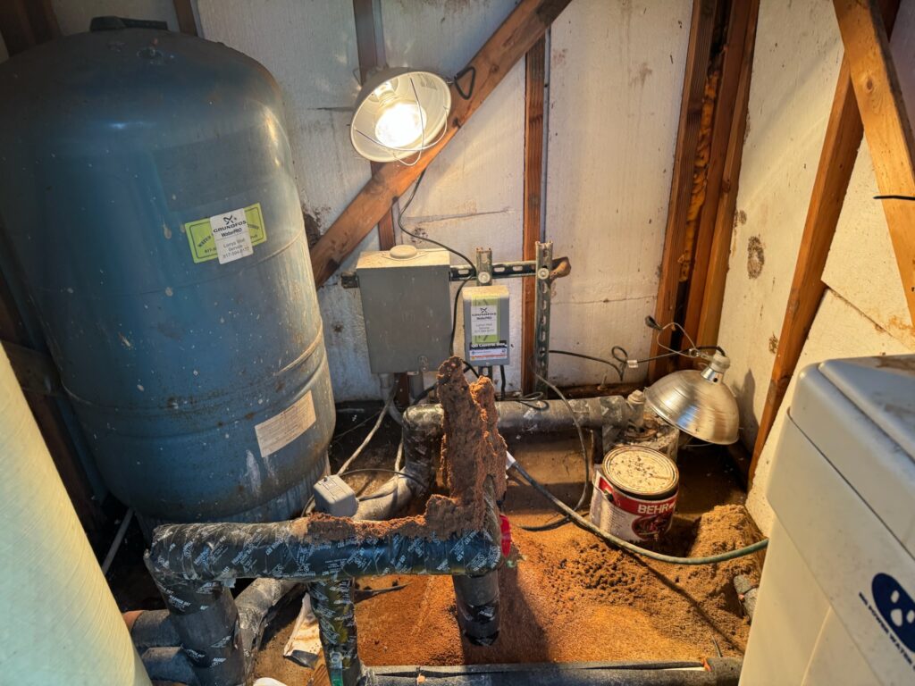 Professional plumber servicing a residential water heater system in Aledo, TX