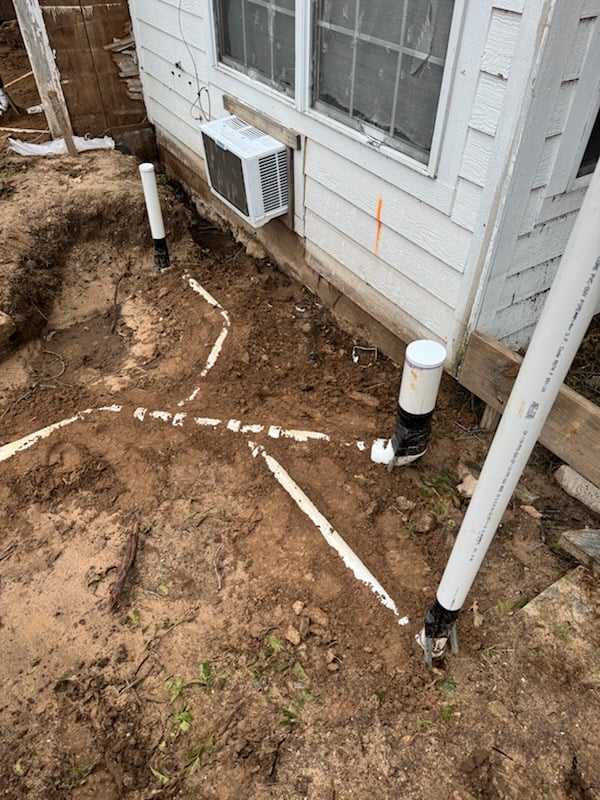 Marked sewer line trench layout before excavation at a home in Aledo, TX